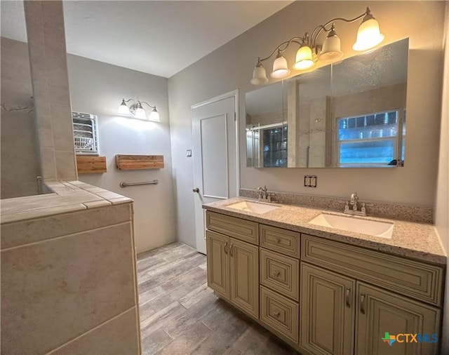 bathroom featuring vanity, hardwood / wood-style flooring, and a shower with shower door