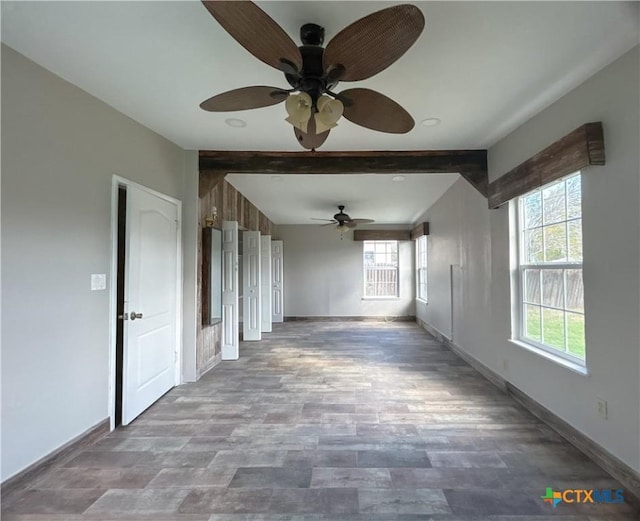 empty room featuring ceiling fan and beam ceiling