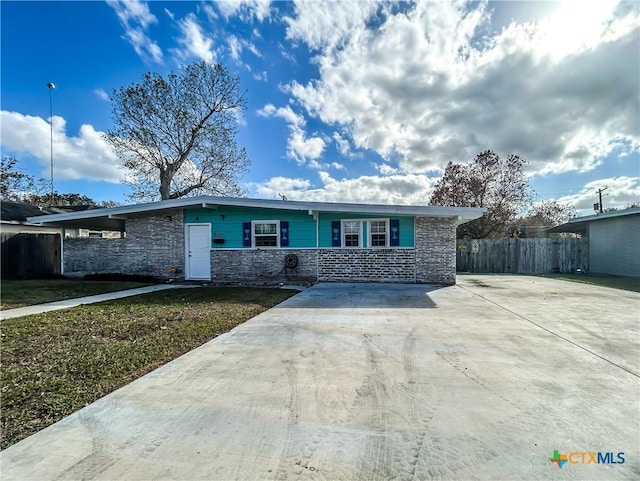 ranch-style home with fence and a front lawn