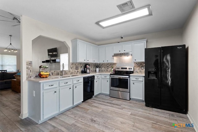 4203 Rambling Range Dr, Killeen, TX 76549 - kitchen featuring black appliances, under cabinet range hood, light wood finished floors, light countertops, and backsplash