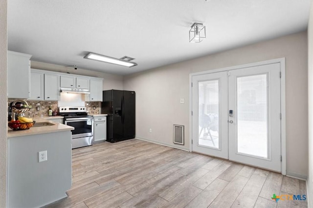 4203 Rambling Range Dr, Killeen, TX 76549 - kitchen featuring stainless steel range with electric stovetop, black fridge, french doors, light countertops, and light wood finished floors