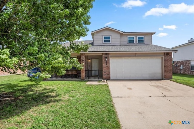 4203 Rambling Range Dr, Killeen, TX 76549 - traditional home with brick siding, driveway, a garage, a front lawn, and a shingled roof