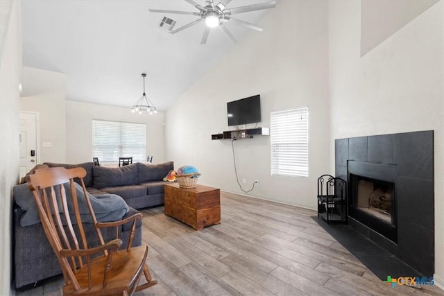 4203 Rambling Range Dr, Killeen, TX 76549 - living area featuring high vaulted ceiling, wood finished floors, a ceiling fan, and a tiled fireplace