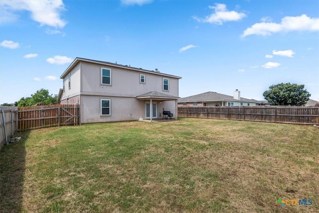 4203 Rambling Range Dr, Killeen, TX 76549 - back of property featuring a fenced backyard, a patio area, and stucco siding
