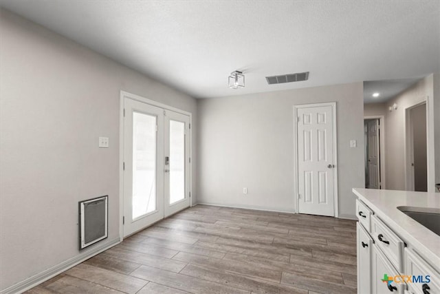 4203 Rambling Range Dr, Killeen, TX 76549 - unfurnished dining area with french doors and light wood-style flooring