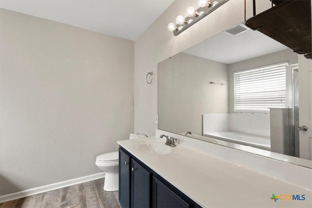 4203 Rambling Range Dr, Killeen, TX 76549 - bathroom featuring wood finished floors, a garden tub, and vanity