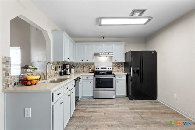 4203 Rambling Range Dr, Killeen, TX 76549 - kitchen featuring black fridge, electric range, light countertops, and decorative backsplash