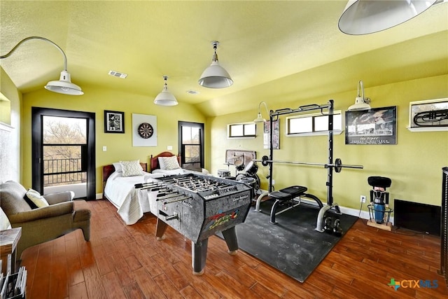 recreation room with baseboards, wood finished floors, and vaulted ceiling