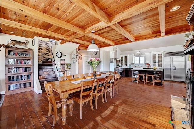 dining area with wooden ceiling, beam ceiling, stairway, and wood finished floors