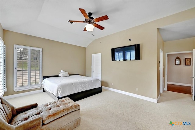 bedroom with ceiling fan, lofted ceiling, baseboards, and light carpet