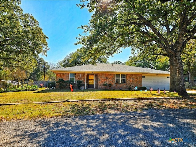 single story home featuring a garage and a front yard