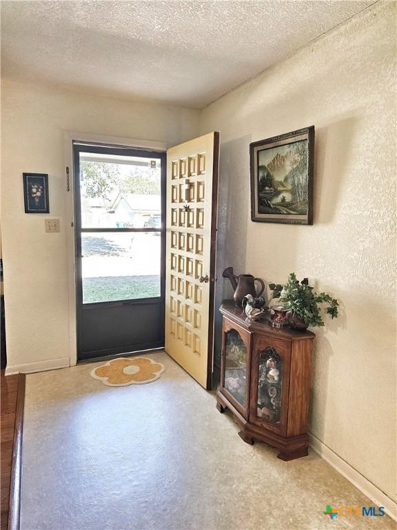 foyer featuring a textured ceiling