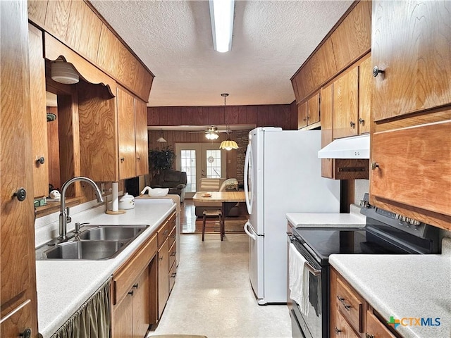 kitchen with a textured ceiling, ceiling fan, sink, pendant lighting, and stainless steel electric range oven