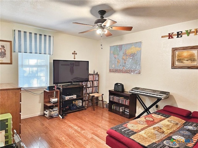 bedroom with wood-type flooring, a textured ceiling, and ceiling fan