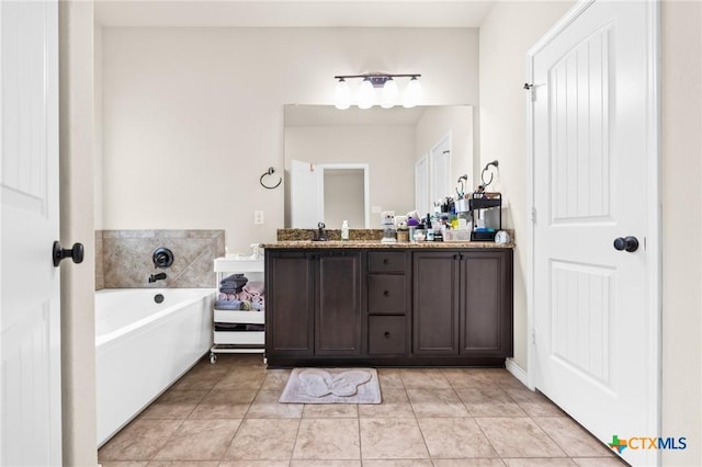 full bathroom featuring double vanity, tile patterned flooring, a sink, and a bath