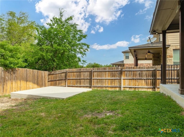 view of yard with ceiling fan, a fenced backyard, and a patio area