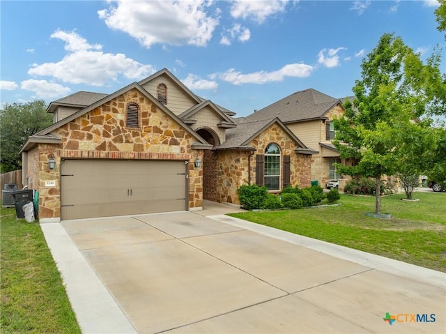 view of front facade featuring a front lawn, stone siding, roof with shingles, concrete driveway, and an attached garage