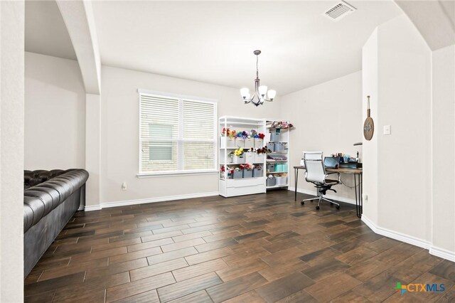 office with baseboards, a notable chandelier, wood finished floors, and visible vents