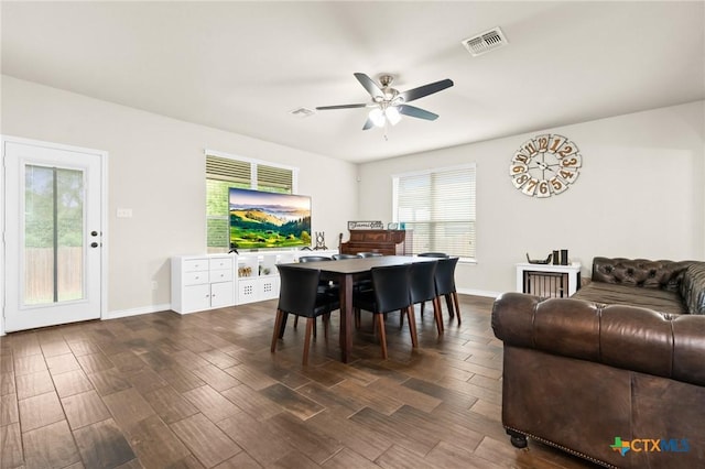 dining area with a ceiling fan, visible vents, dark wood-style floors, and a healthy amount of sunlight