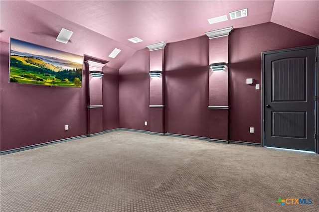 cinema room with vaulted ceiling, carpet flooring, and visible vents