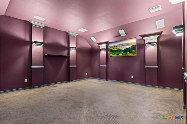 cinema room featuring visible vents, carpet flooring, baseboards, and vaulted ceiling