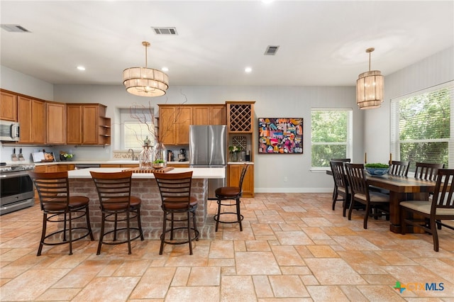 kitchen featuring visible vents, stainless steel appliances, open shelves, and a sink