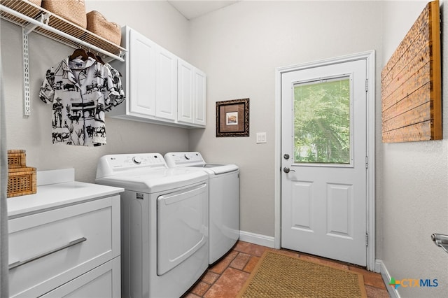 laundry room with baseboards, cabinet space, and washing machine and dryer
