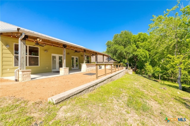 exterior space with a patio, french doors, ceiling fan, and metal roof