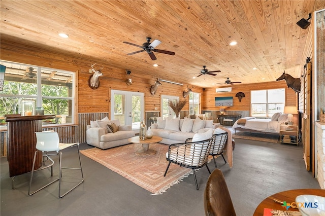 living room featuring wood ceiling, a healthy amount of sunlight, and recessed lighting