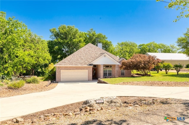 ranch-style home with a chimney, brick siding, a garage, a front yard, and concrete driveway