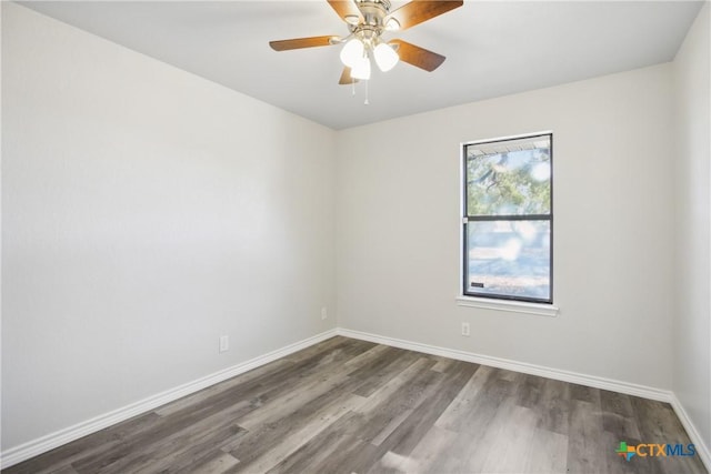 unfurnished room with ceiling fan and dark hardwood / wood-style flooring