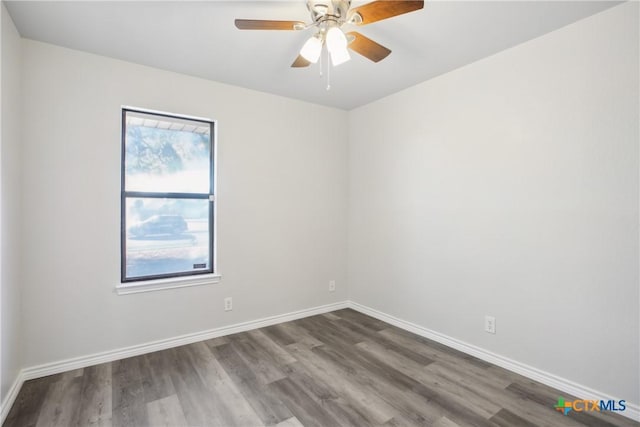 unfurnished room featuring ceiling fan and dark wood-type flooring