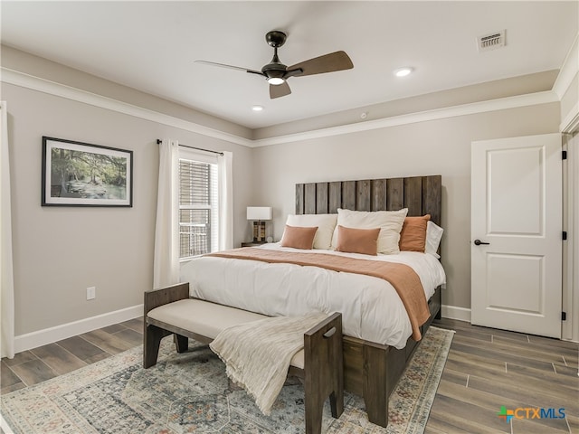 bedroom featuring dark hardwood / wood-style flooring and ceiling fan