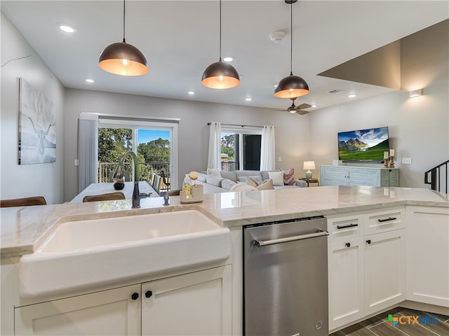 kitchen with stainless steel dishwasher, light stone countertops, pendant lighting, and dark hardwood / wood-style flooring