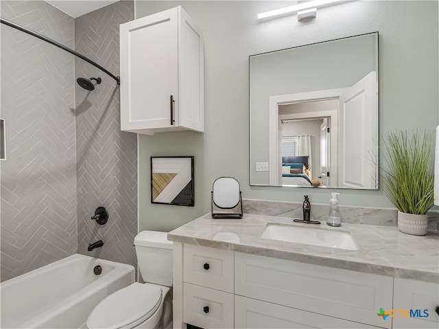 full bathroom with vanity, tiled shower / bath, and toilet