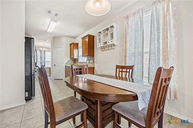 3610 Parkmill Dr, Killeen, TX 76542 - dining room featuring light tile patterned floors, baseboards, and a chandelier