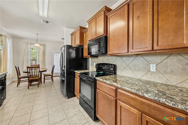 3610 Parkmill Dr, Killeen, TX 76542 - kitchen featuring black appliances, backsplash, brown cabinetry, light stone countertops, and light tile patterned floors