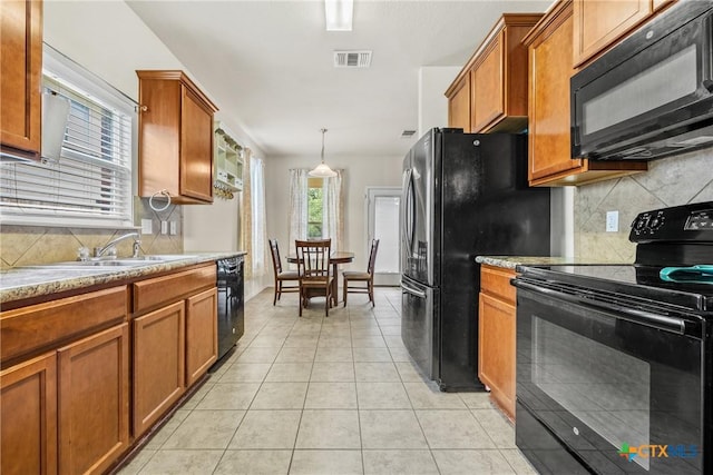 3610 Parkmill Dr, Killeen, TX 76542 - kitchen featuring black appliances, brown cabinets, and tasteful backsplash
