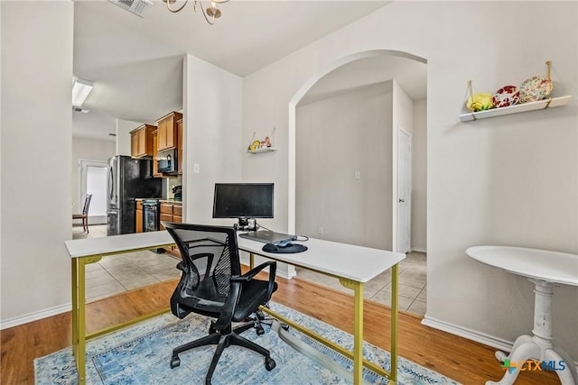 3610 Parkmill Dr, Killeen, TX 76542 - office with arched walkways, light wood-style floors, baseboards, and a chandelier