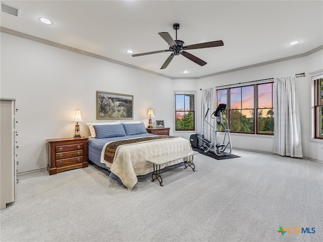 carpeted bedroom with ceiling fan and ornamental molding