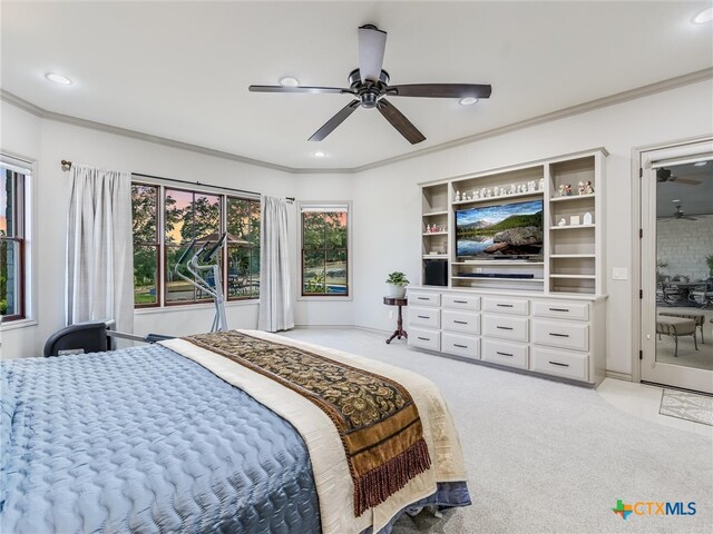 carpeted bedroom with ceiling fan and crown molding