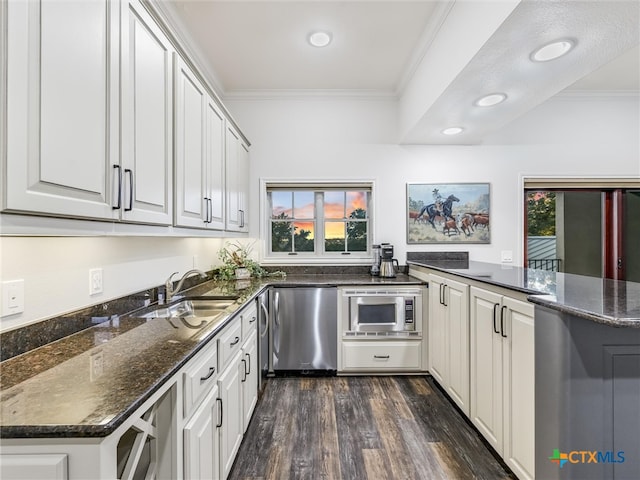 kitchen featuring white cabinetry, kitchen peninsula, sink, and plenty of natural light