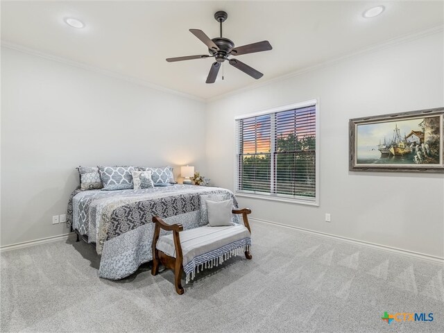 bedroom featuring ceiling fan, light carpet, and crown molding