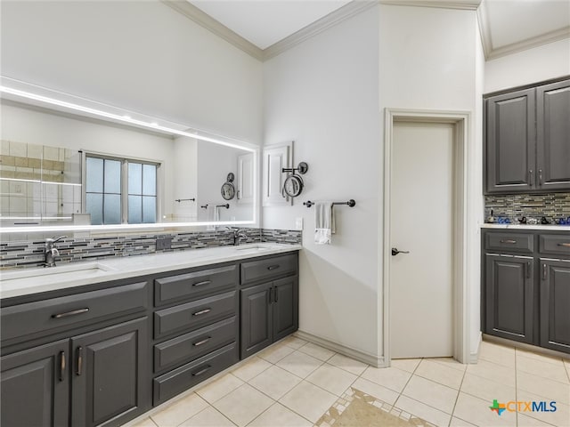 bathroom with tasteful backsplash, vanity, tile patterned flooring, and crown molding