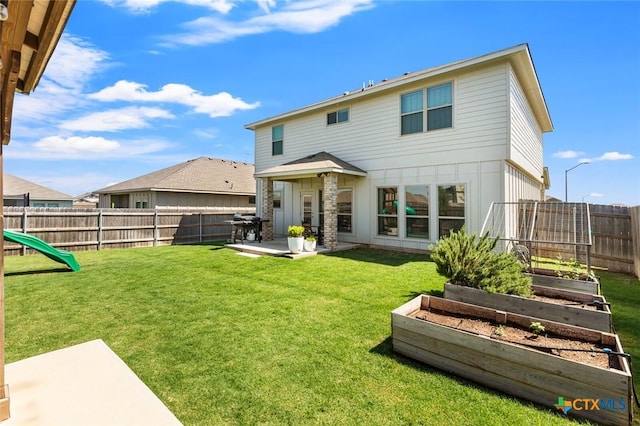 back of property featuring a vegetable garden and a patio