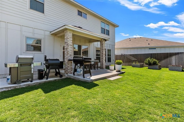 rear view of property with a patio area and stone siding