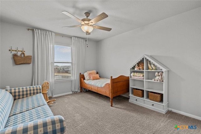 carpeted bedroom with a ceiling fan and baseboards