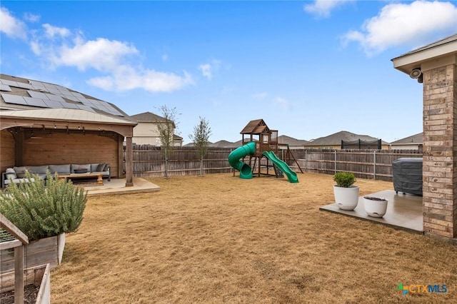 view of playground with a patio, a fenced backyard, and outdoor lounge area