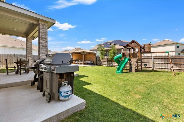 view of yard featuring a playground, a patio, a gazebo, and a residential view