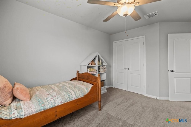 carpeted bedroom with a closet, visible vents, a ceiling fan, and baseboards